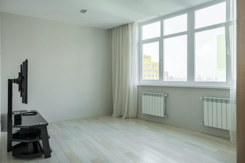 Spacious and bright minimalist apartment with large windows and hardwood floors.