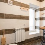 Elegant bathroom featuring a rustic wood vanity and modern fixtures in natural light.