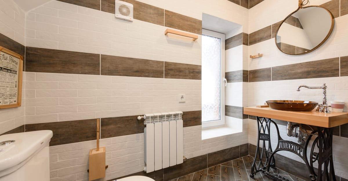 Elegant bathroom featuring a rustic wood vanity and modern fixtures in natural light.